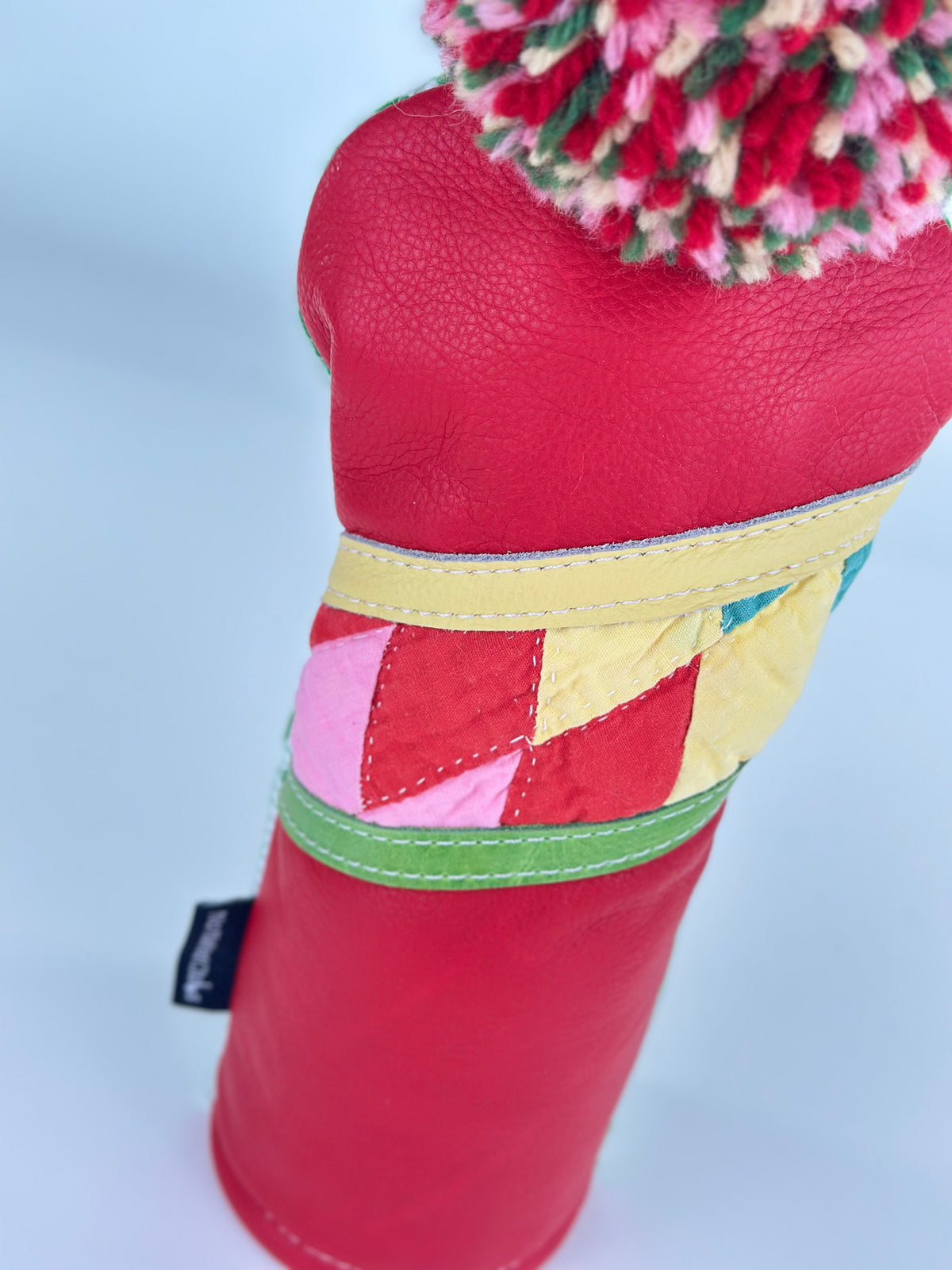 Close-up Cherry Picnic fairway headcover with red leather and handstitched vintage quilt detail