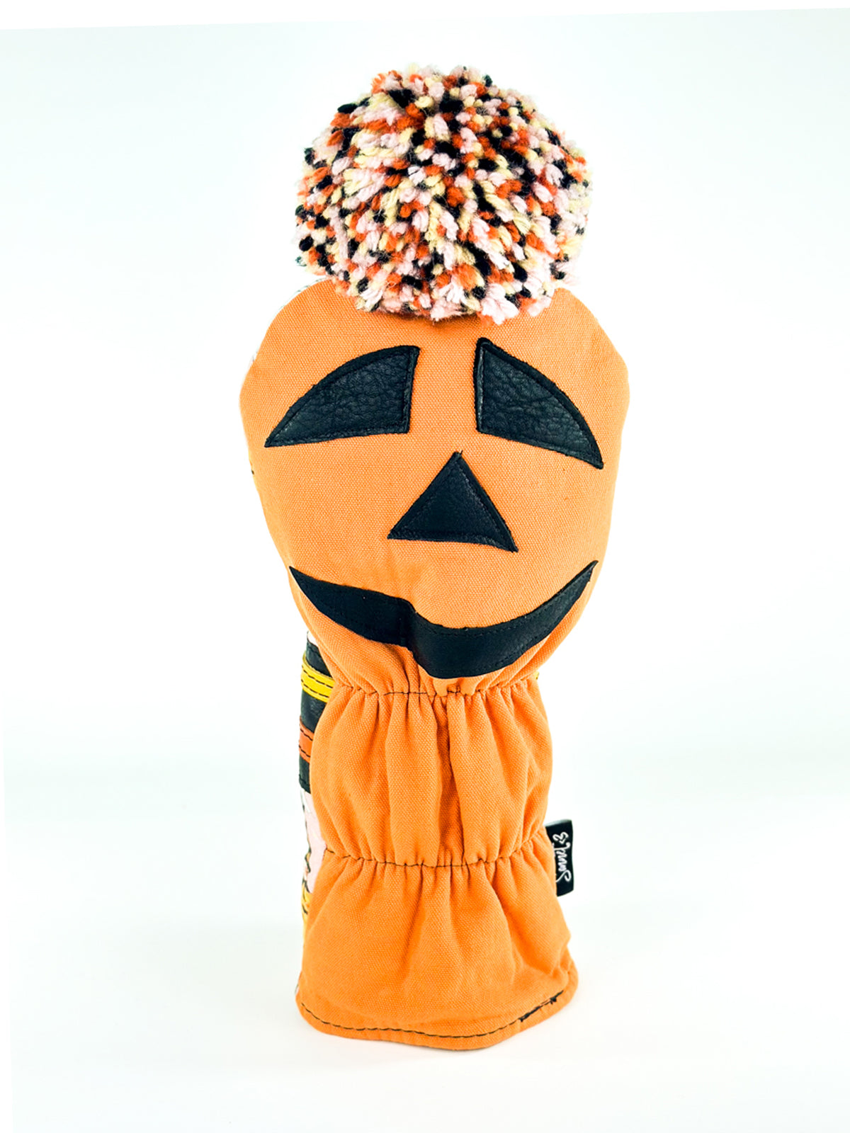 Back view of Pumpkin Moon driver headcover with orange jack-o'-lantern face and wool pom pom